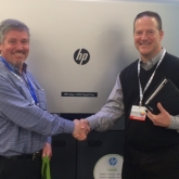 Shaking hands with Kirk McLean, Director of General Commercial Print Segment of HP Indigo