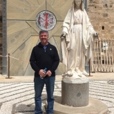 Jay standing by the statue of the Virgin Mary at the Church of the Annunciation in Nazareth